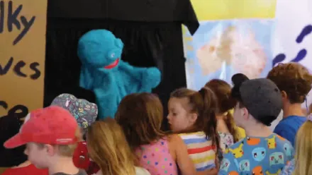 Children watching a puppet show at Sunnyfest